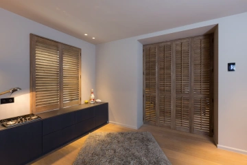 Slaapkamer met beitskleur houten shutters