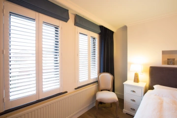 houten shutters als raamdecoratie in de slaapkamer