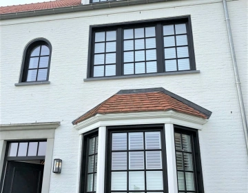 Zwarte shutters in erker