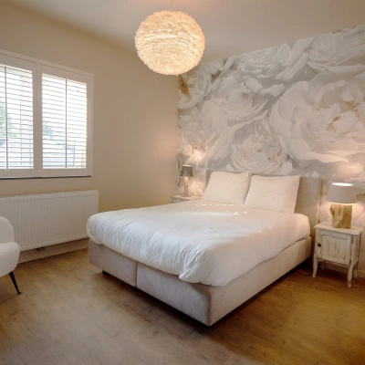 Slaapkamer van B&B met witte shutters